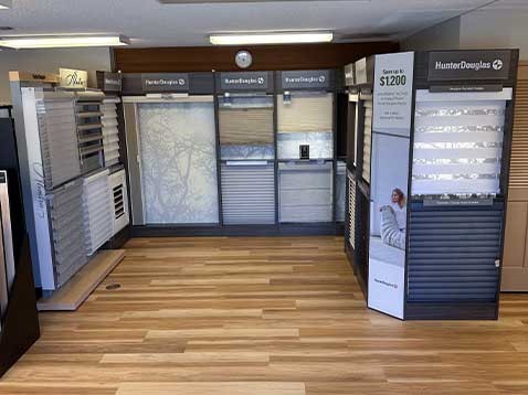Store interior showcasing several different types of window coverings