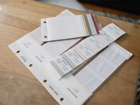 Fabric swatches on a wooden desk